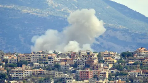 Smoke rises from buildings in the Lebanese village of Khiam