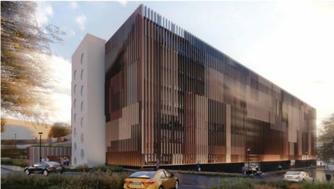 A artist impression of what the proposed car park could look like. It has lots of thin vertical bronze corrugated metal shafts as an exterior layer around a rectangular building.