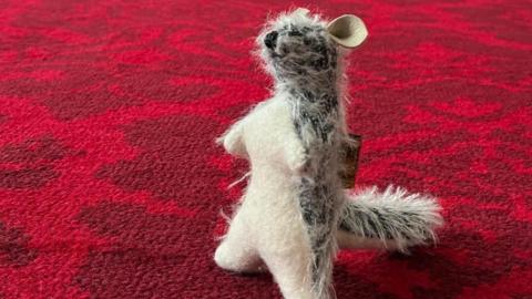 Roo on the carpet at Buckingham Palace - it's a teddy bear on that looks like the character from Winnie-the-Pooh 