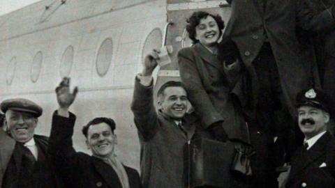 Passengers including Dai and Kathleen Hawkins from Llanharan waving as they board the Avro Tudor aircraft on its way to Ireland.