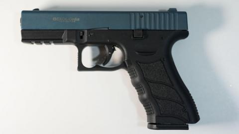 A black Ekol hand pistol