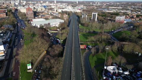 An aerial view of Gateshead flyover. It is a long road bridge with two lanes travelling northbound towards Newcastle and two lanes travelling southbound into Gateshead.