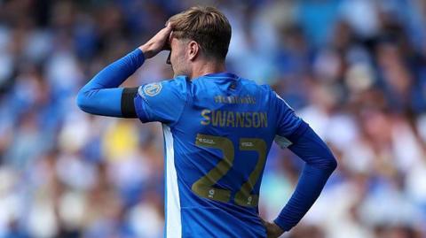 Portsmouth's Zak Swanson with his hand over his face during their defeat by QPR
