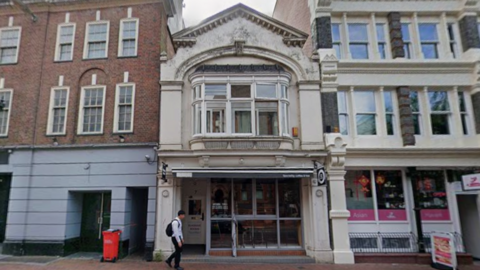A general view picture of the building in Blagrave Street in Reading, a two-storey building surrounded by larger buildings.