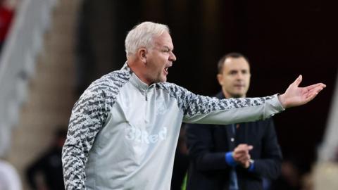 Adi Viveash making a gesture with his left-hand during Middlesbrough's win over Birmingham City with Blue head coach Chris Davies in the background