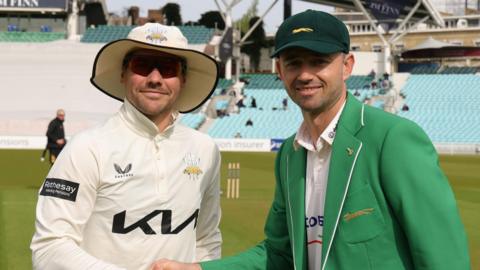 Captains Rory Burns and Ian Holland shake hands at The Oval
