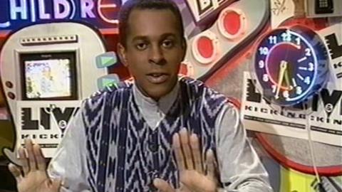 Andi Peters sits behind The Broom Cupboard desk