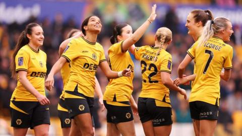 Wolves players celebrate after scoring a goal