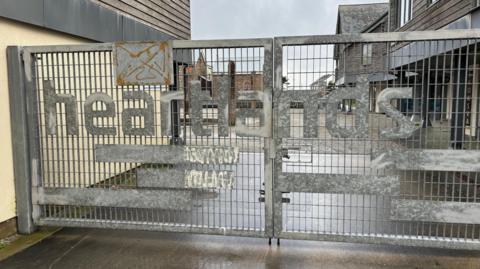 A picture of the gates of the front entrance to Heartlands.