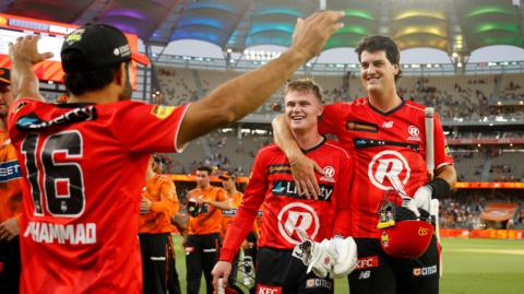 Ollie Peake (left) and Sam Elliott walk off the field after Melbourne Renegades beat Perth Scorchers