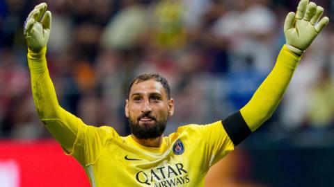 Gianluigi Donnarumma raises his arms in celebration while playing for Paris St-Germain