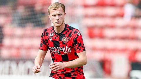 Ryan Finnigan warms up for Walsall ahead of a League Two match