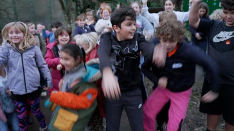 children-dancing-together-in-their-school-yard