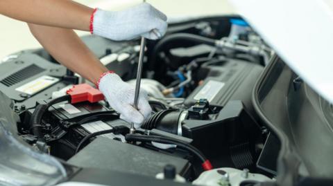 A mechanic undertaking an MOT.