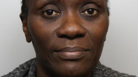 A police mugshot of Lydia Mugambe