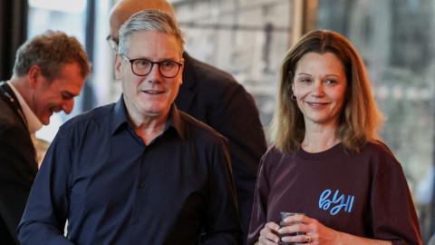 PM Keir Starmer stands next to his wife Victoria