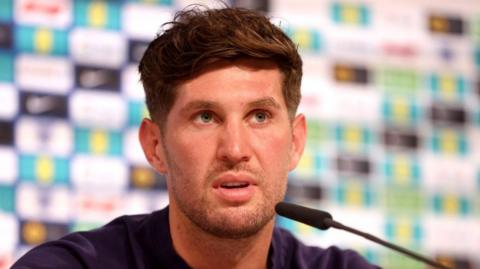 John Stones speaks at a news conference