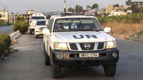 File photo of a convoy of white cars with UN painted on the hood driving through the southern Lebanon town of Tyre