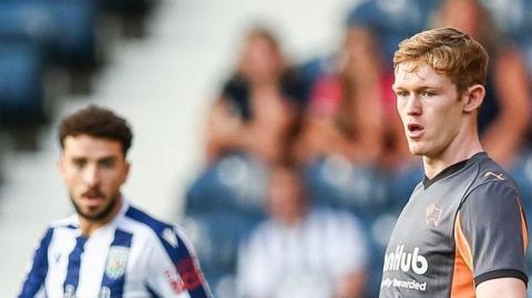 Jake Rooney in action for Derby