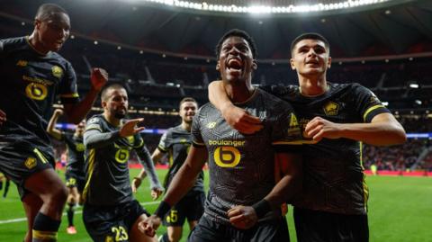 Jonathan David celebrates with team-mates after scoring Lille's second against Atletico Madrid