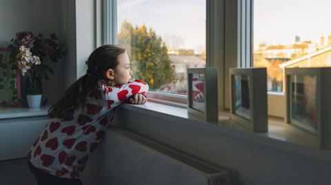 Girl looking out the window