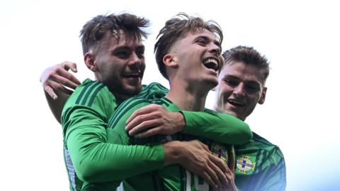Conor Bradley, Isaac Price and Justin Devenny celebrate