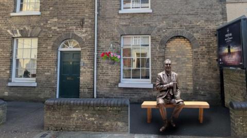 An artist's impression of how the statue of Roy Hudd could look if approved. It shows a bronze life-size statue of Hudd sitting on a wooden bench in front of a property.