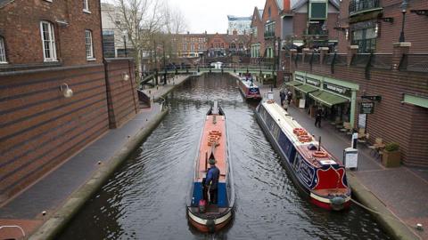 Birmingham canal in Brindley Place with three canal boats 