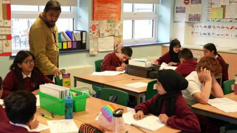 A teacher in a classroom with children