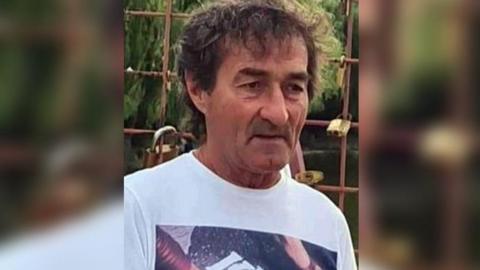 Vasile Predoiu, who has brown hair and is wearing white t-shirt
