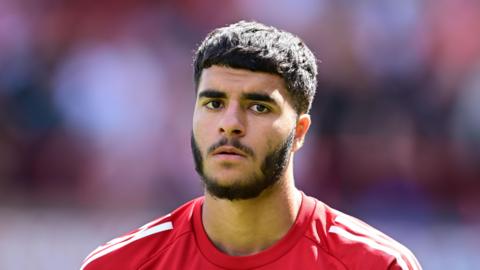 Botan Ameen standing on the pitch during a match for Swindon