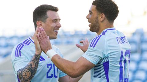 Che Adams celebrates scoring for Scotland