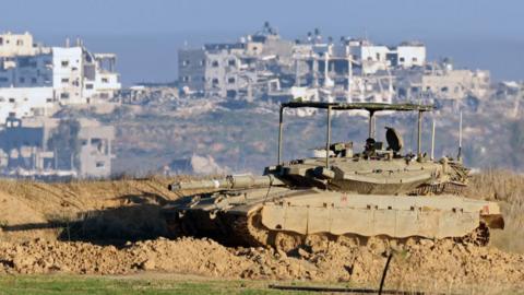  Israeli army tank drives into position near Israel's southern border with the Gaza Strip on January 14, 2025