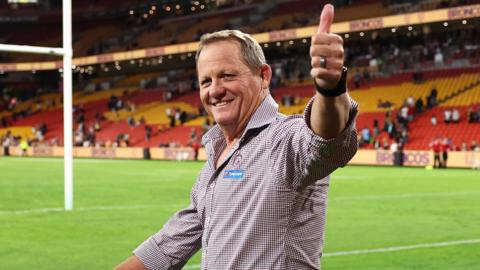 Kevin Walters gives a thumbs up to fans while doing a lap of honour of the pitch at Suncorp Stadium after Brisbane Broncos beat Manly Sea Eagles in the NRL.