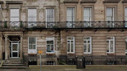 Rodney House on Canning Street is a yellow brick terraced building with large white sash windows
