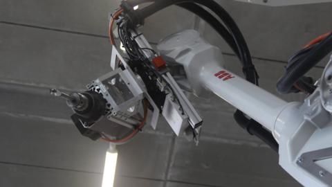 Construction robot wields a drill
