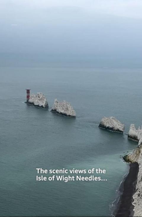 A series of white rocks can be seen above the sea.