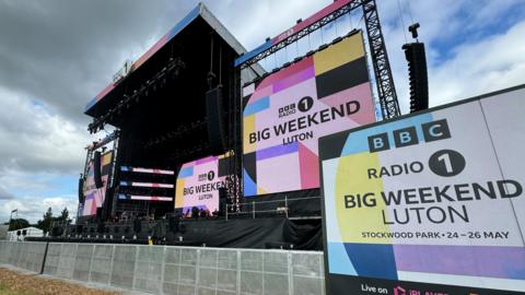 A large stage at Big Weekend in Luton, with large advertising board which reads "Big Weekend Luton"