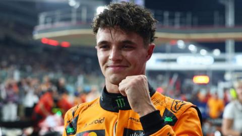 Lando Norris smiles and clenches his fist in celebration after qualifying on pole for the Abu Dhabi Grand Prix