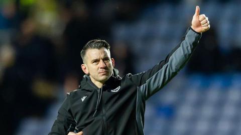 Matt Bloomfield acknowledges the Oxford United supporters at the Kassam Stadium