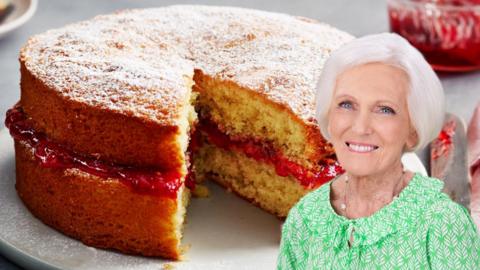 A photograph of Mary Berry against a two-layered sponge cake. © Neil Genower