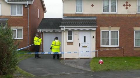 Officers outside house 