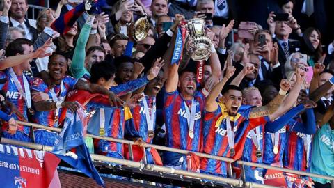 Crystal Palace players lift the FA Cup trophy at Wembley