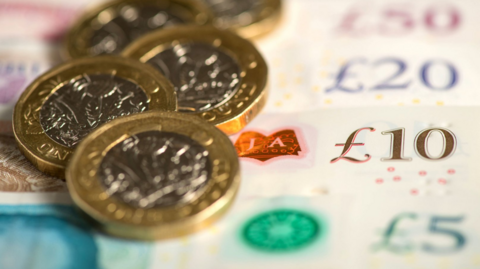 A generic shot of pound notes and coins