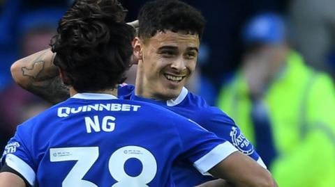 Cardiff's Alex Robertson celebrates with Perry Ng