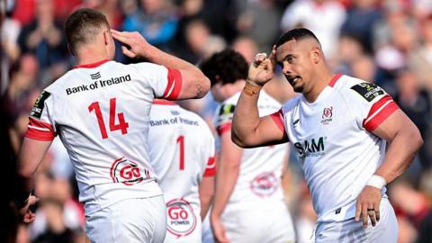 Juarno Augustus (right) holds finger to head in salute after scoring a try