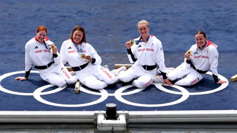 Hannah Scott (second from right) with her Olympic gold medal