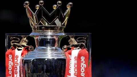 The Premier League trophy, adorned with red and white ribbons for champions Arsenal, sits pitchside at Selhurst Park beforer the end of season presentation and celebrations