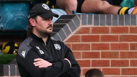 Craig Harrison looks on from the touchline during a game