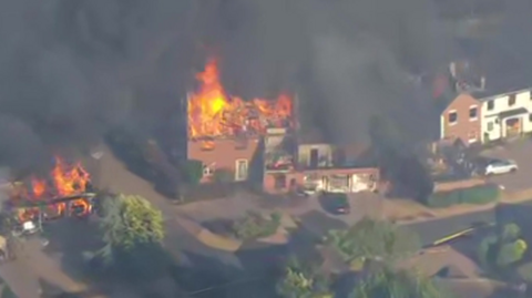 Fire raging in a house.